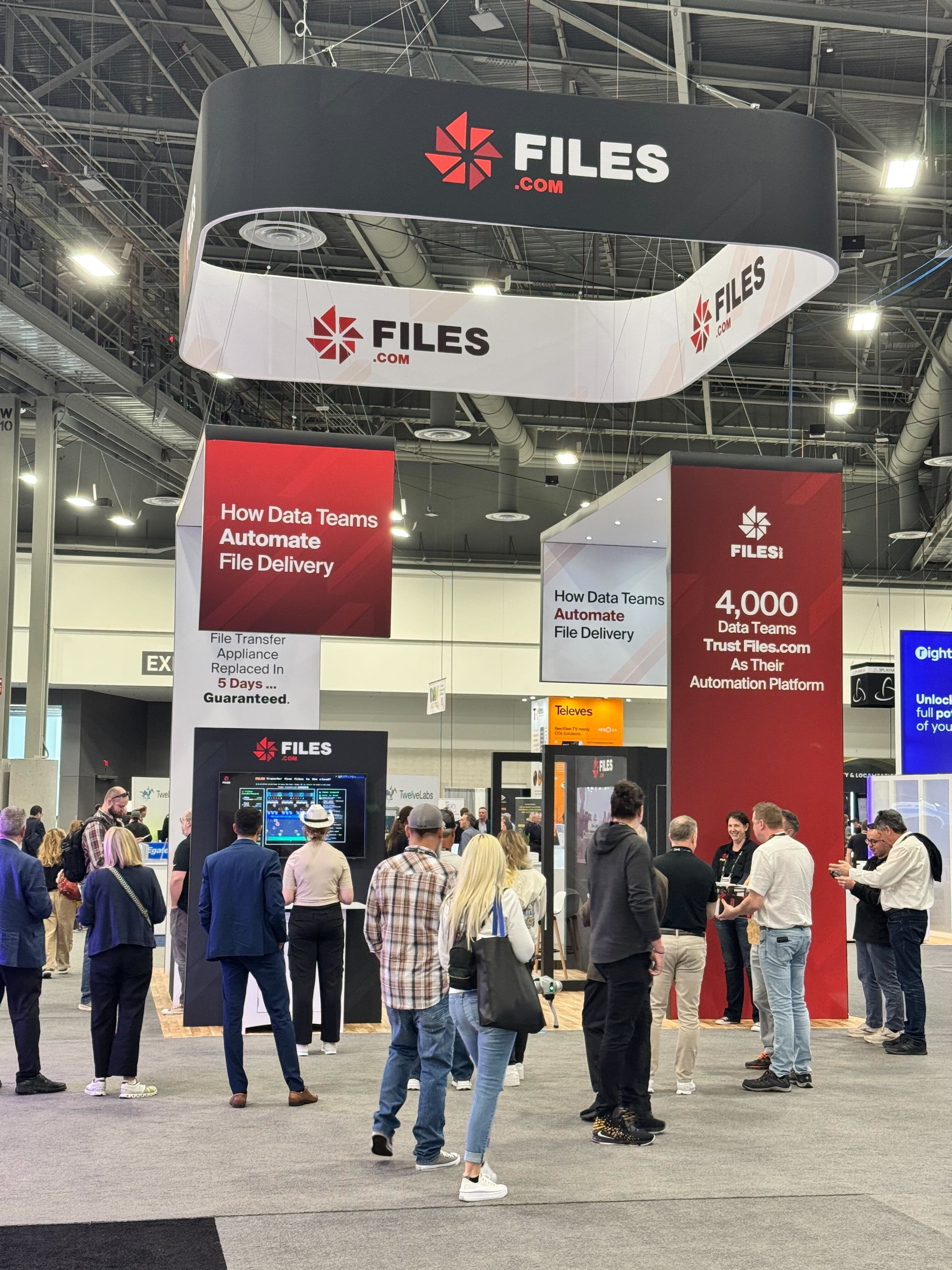 The Files.com booth at NAB Show, under the Files.com sign and the How Data Teams Automate File Delivery panels